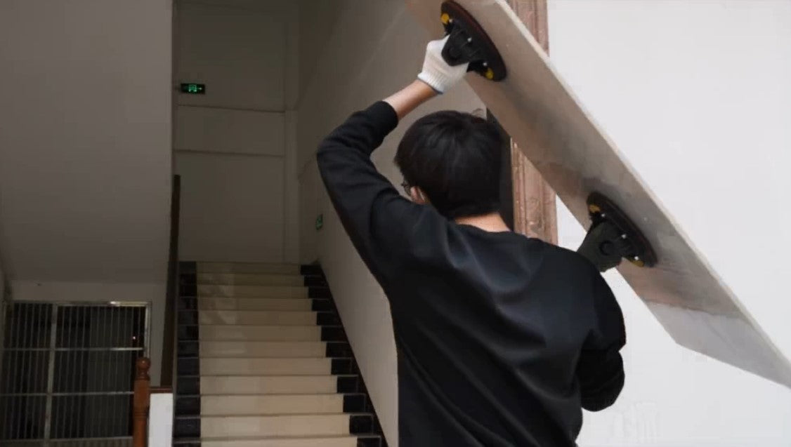 Chico cargando una baldosa de gran formato